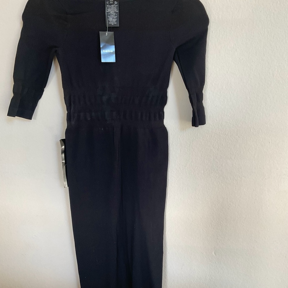 Brand new, never worn black sexy dress with 3/4 sleeves and see through panels